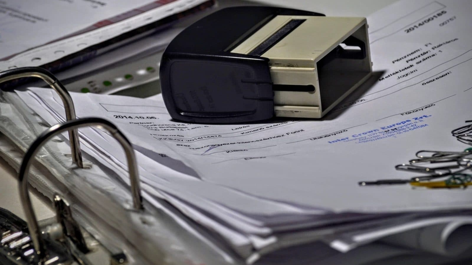 A ring binder holding a thick set of printed and tabbed documents.