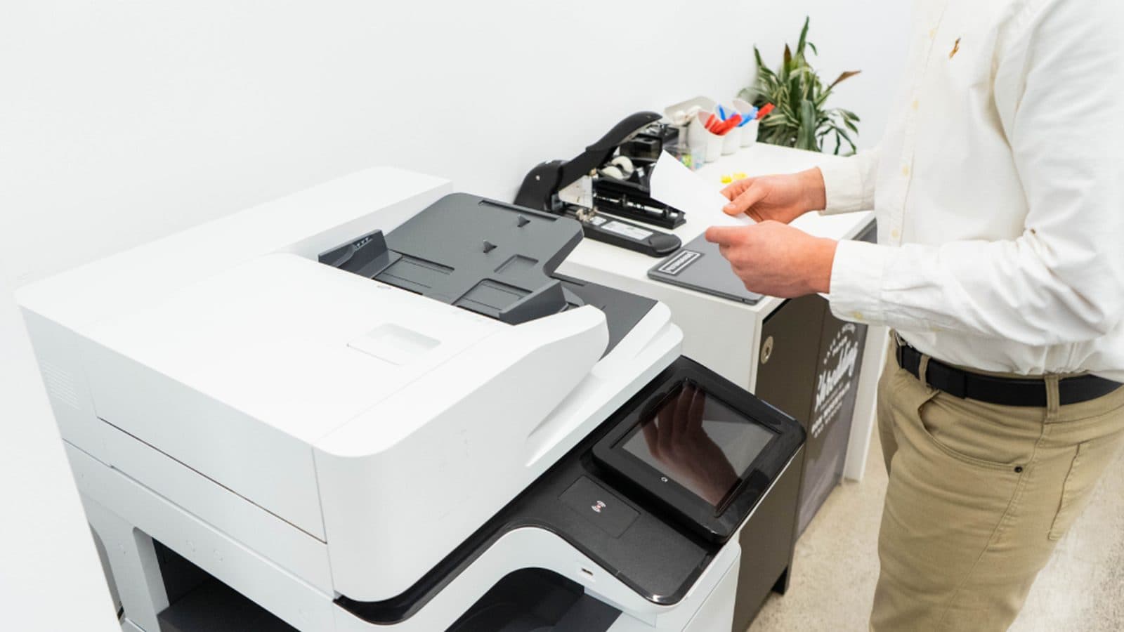 A multifunction office copier and printer set up for a production run.